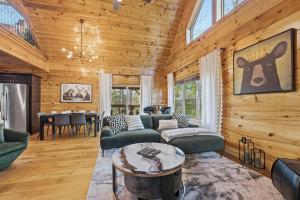 a living room with wooden walls and a ceiling with windows at Grizzly Glam in Gatlinburg