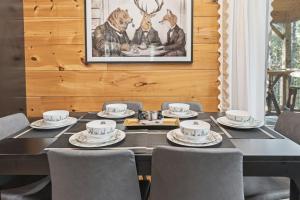 a dining room with a black table and chairs at Grizzly Glam in Gatlinburg