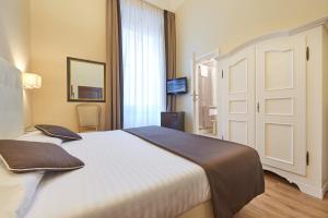 Postel nebo postele na pokoji v ubytování Hotel Cosimo de' Medici
