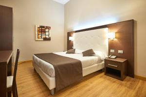 Postel nebo postele na pokoji v ubytování Hotel Cosimo de' Medici