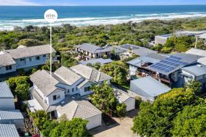 an aerial view of a residential neighborhood with houses and the ocean at Whispering Waves Pet Friendly Steps to Beach in Peregian Beach
