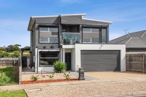 a house with a garage in front of it at Tranquil Turnberry in Saint Leonards