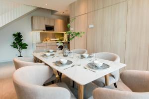 a dining room with a white table and chairs at La,mer Butik Hotel in Kota Kinabalu