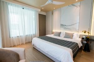 a bedroom with a bed and a large window at La,mer Butik Hotel in Kota Kinabalu +22 photos
