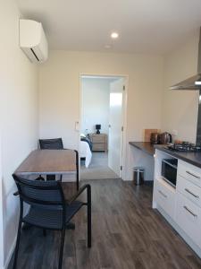 a kitchen and living room with a table and a bed at Suncrest Villas in Cromwell +11 photos