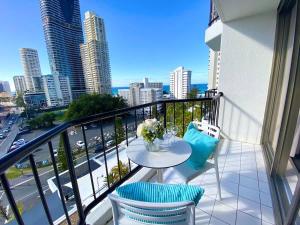 a balcony with a table and chairs and a view of a city at Ocean View Suite 2 Beds Wi-Fi Netflix in Gold Coast