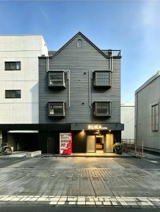 a black building with a red sign on it at Ruka Hotel Tennoji in Osaka