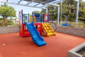 a playground with a slide and a slideintend at Hotel Clipper in Rockingham