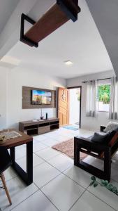 a living room with a couch and a table at Aconchego e Estilo em Brusque in Brusque +10 photos