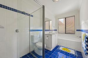 a bathroom with a toilet and a glass shower at 41 Blanche Pde, Hindmarsh Island in Hindmarsh Island +17 photos