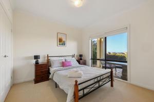 a bedroom with a bed and a large window at 41 Blanche Pde, Hindmarsh Island in Hindmarsh Island