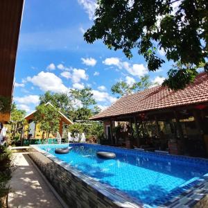 a swimming pool in front of a building at Retreat Bungalow in Phong Nha