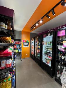 an aisle of a grocery store with food and drinks at Apartamento com academia - Toledo in Toledo