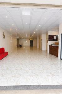 a large empty room with a red couch in a building at Hưng Phát Hotel Nghệ An in Vinh +24 photos