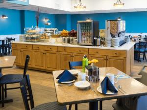 a dining room with two tables and a counter at Atlantic Oceanside Hotel & Conference Center in Bar Harbor