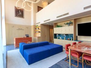a living room with a blue couch and a table at Brada Collection Stays in Guadalajara