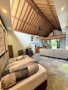 a bedroom with a bed and a living room at Bayshore Villa in Candidasa +75 photos