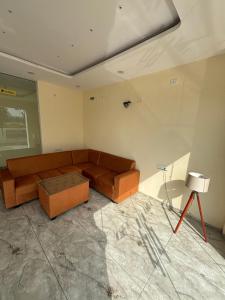 a living room with a couch and a table at Raman Resort Hotel and Banquet in Gagargārh