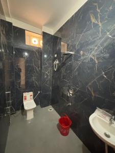 a bathroom with a toilet and a sink at Raman Resort Hotel and Banquet in Gagargārh
