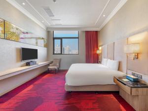 a hotel room with a bed and a television at CHECK inn Select Tainan Yongkang in Yongkang