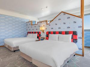 two beds in a room with a wall at CHECK inn Select Tainan Yongkang in Yongkang +29 photos