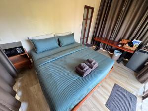 a large bed in a room with a blue bedvisor at O Zen Resort in Ko Man Nai