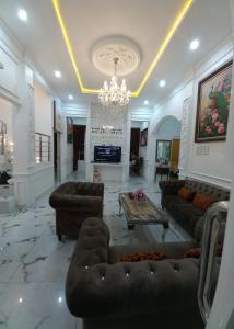 a large living room with couches and a chandelier at Batu Villa Sakura in Batu