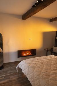 a bedroom with a bed and a fireplace at Sole Suite & Boutique Rooms in Norma