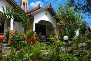 a house with a lot of plants in front of it at Gili Nyepi in Gili Trawangan