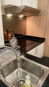 a kitchen sink with a dish rack above it at Buasri By Ohm in Patong Beach +51 photos