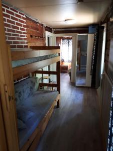 a room with a staircase and a brick wall at Pääsky Schwalbe-cabin by crater lake in Varpaisjärvi