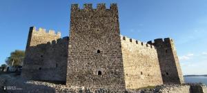 a large stone castle with a blue sky in the background at Studio LIMES in Zatonje