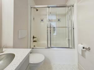 a white bathroom with a toilet and a shower at Quiet Private Room with Ensuite - Broadmead 908 in Victoria