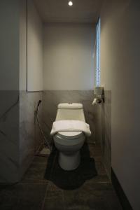 a bathroom with a white toilet in a stall at Hotel Holm Bangkok in Bangkok +31 photos