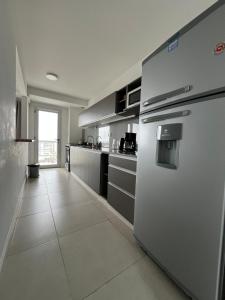 a kitchen with stainless steel appliances and a tile floor at Punta Flecha in Puerto Madryn