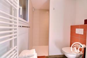 a bathroom with a toilet and a shower at Le cerisier in Cancale