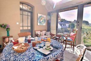 a dining room table with a basket of food on it at Le cerisier in Cancale +11 photos