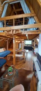a living room with a loft with a couch and a table at Torii Cabañas de Montaña in Villa Carlos Paz +26 photos