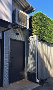 a garage with a air conditioner on top of it at Studio Apartment close to the CBD in Unley