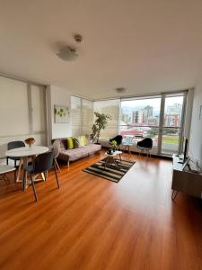 a living room with a couch and a table at BlueZone Apartments in Quito