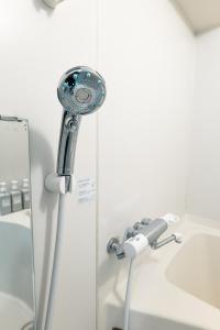 a shower in a bathroom next to a sink at Sapporo Residence 14 in Sapporo +174 photos