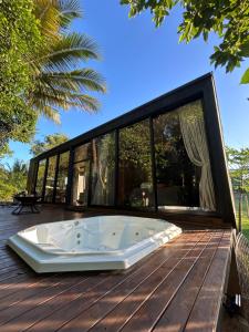 a hot tub on the deck of a house at Chalé Moov in Guarapari