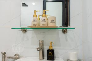 a bathroom with a sink and a shelf with toiletries at Aura Retreat Boutique Hotel Hanoi in Hanoi +79 photos