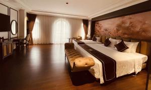 a large bedroom with a large bed with a large headboard at Bảo Long Lào Cai Hotel in Lao Cai