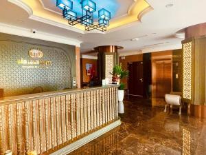 a lobby of a hotel with a staircase and a chandelier at Bảo Long Lào Cai Hotel in Lao Cai