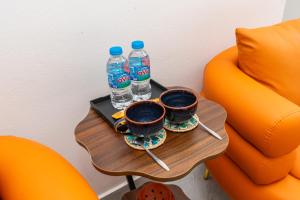 two bottles of water and two cups on a table at Aura Retreat Boutique Hotel Hanoi in Hanoi