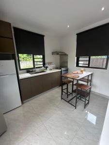 a kitchen with a table and some chairs in it at Matirina Ura lodge in Arue