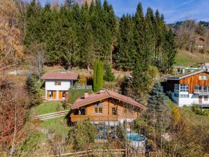 an aerial view of a wooden house with trees at TraumLodge in Kleinsonnberg