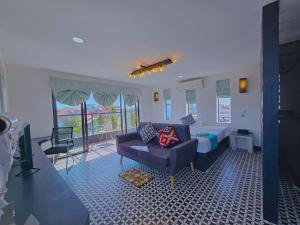 a living room with a bed and a couch at Angkor Rise Residence in Siem Reap