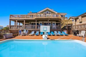 a house with a swimming pool in front of a house at 6119 - Gone Coastal in Nags Head +76 photos
